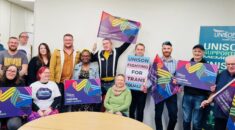 LGBT+ AGM attendees holding placards for LGBT+ workers and Trans rights