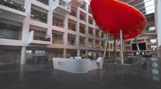 The interior of Solent University with a reception desk and a large red balloon like object known as the Spark