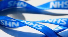 A blue lanyard that says NHS