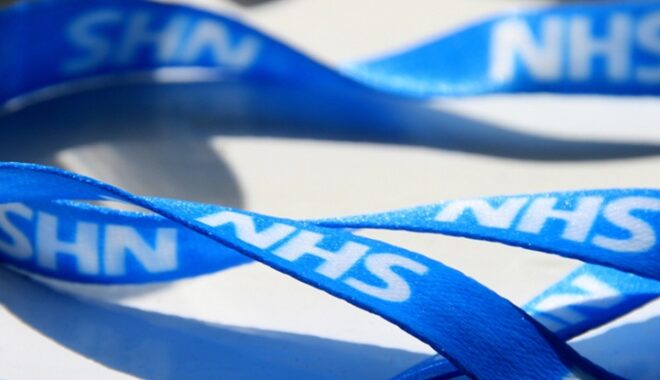 A blue lanyard that says NHS
