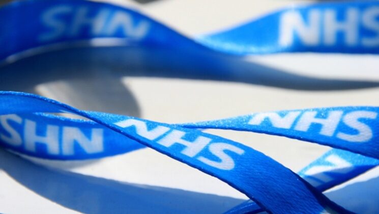 A blue lanyard that says NHS